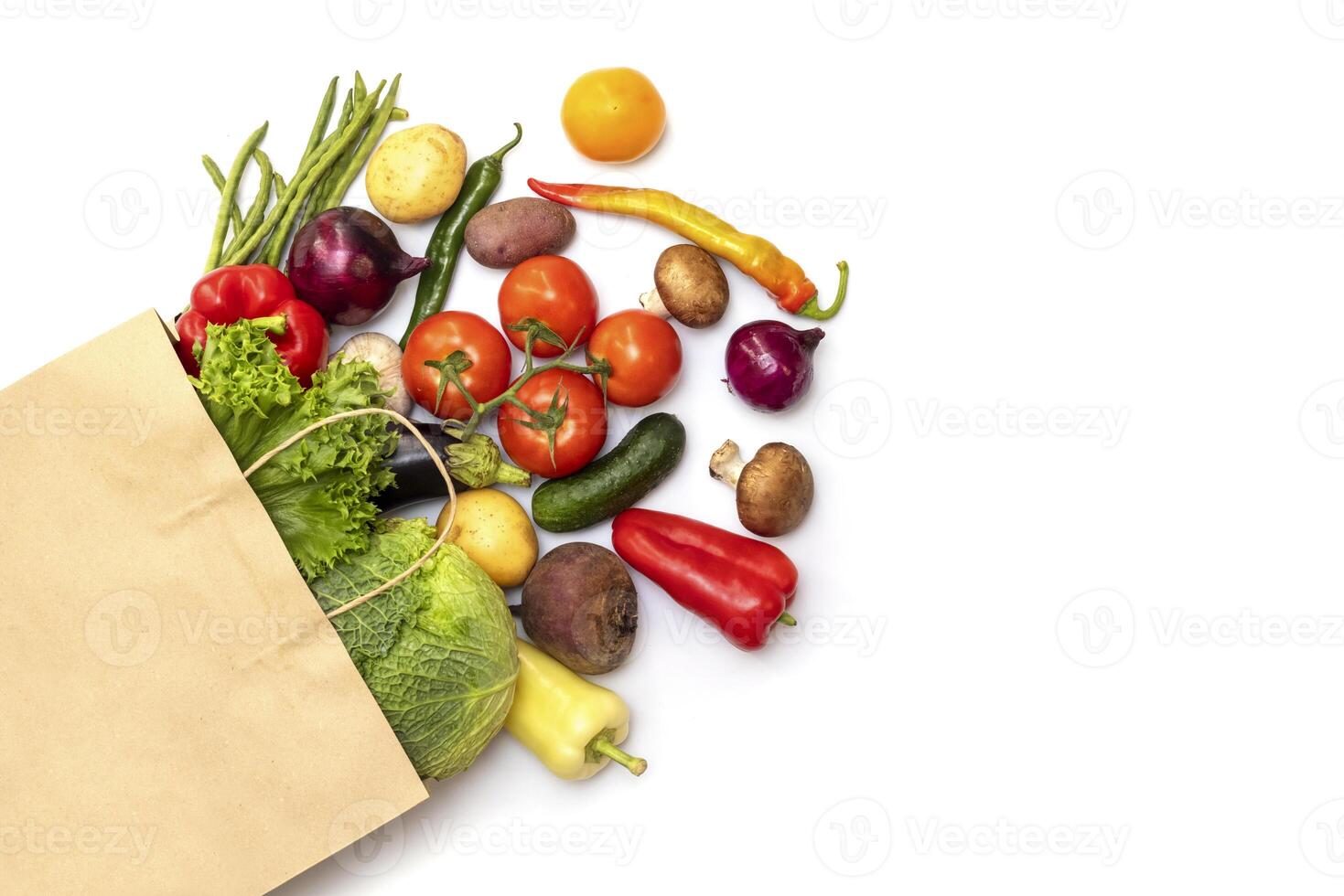 Fresh vegetables in eco friendly paper bag on white background, top view photo