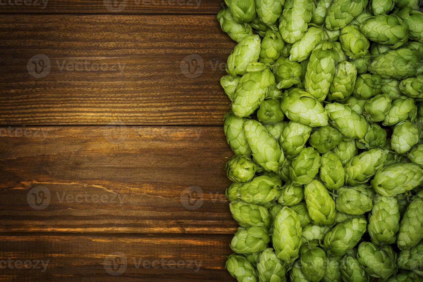 Beer brewing ingredients, green hop cones on a wooden table photo