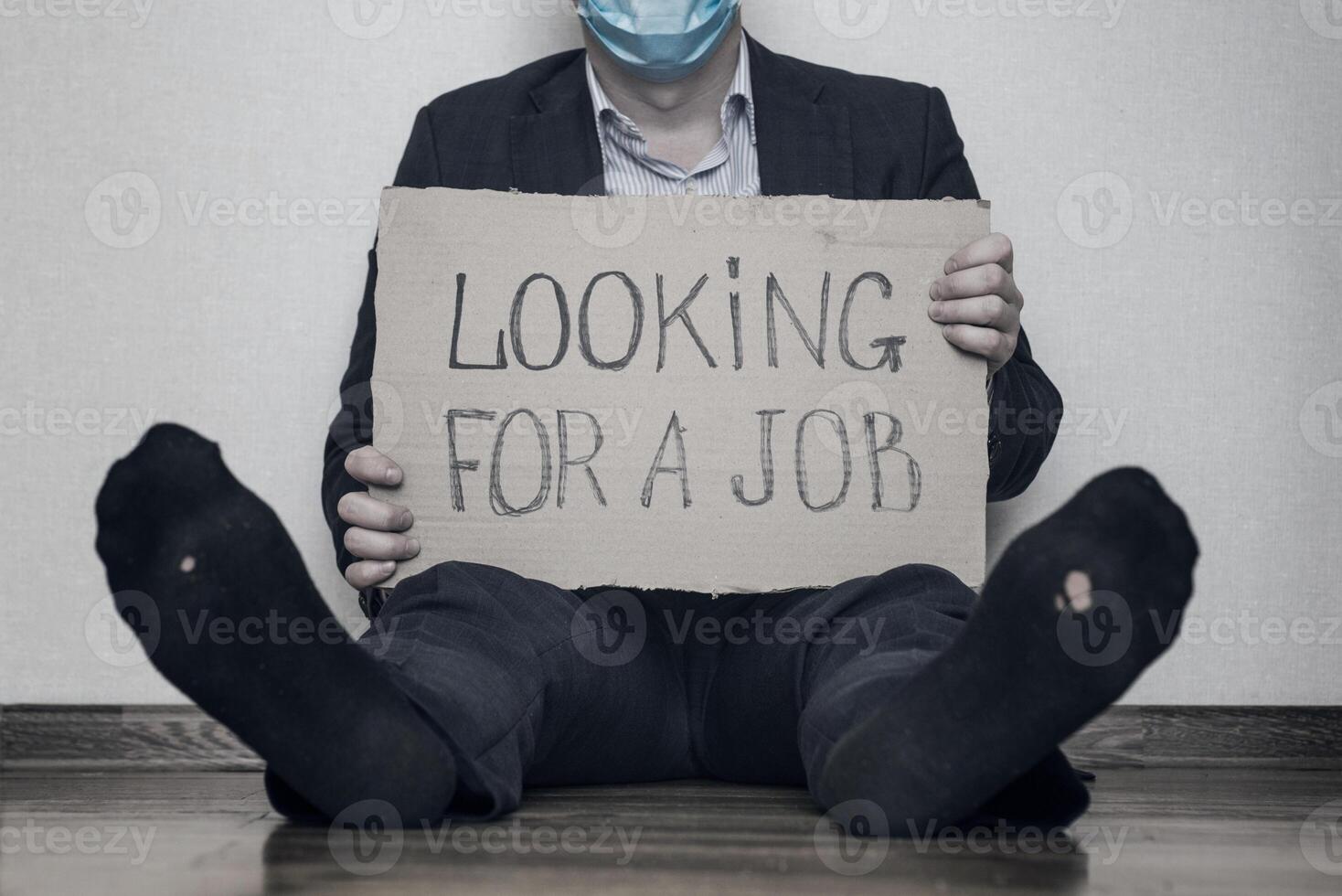 A young businessman who lost his job due to quarantine is looking for a job photo