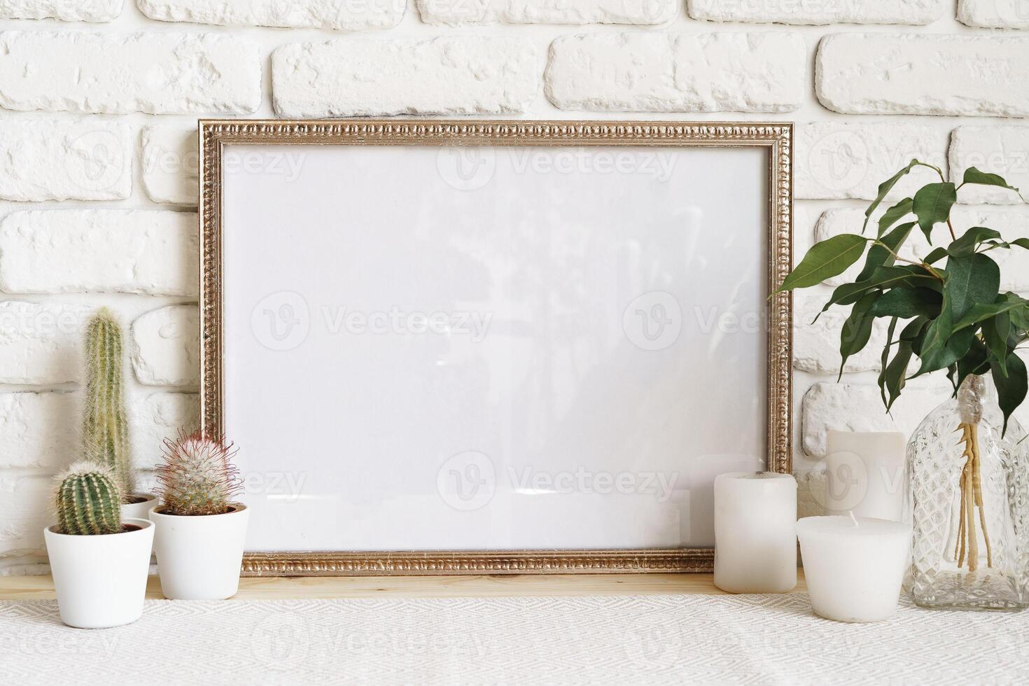 Square wooden photo frame and cactus plants on the table