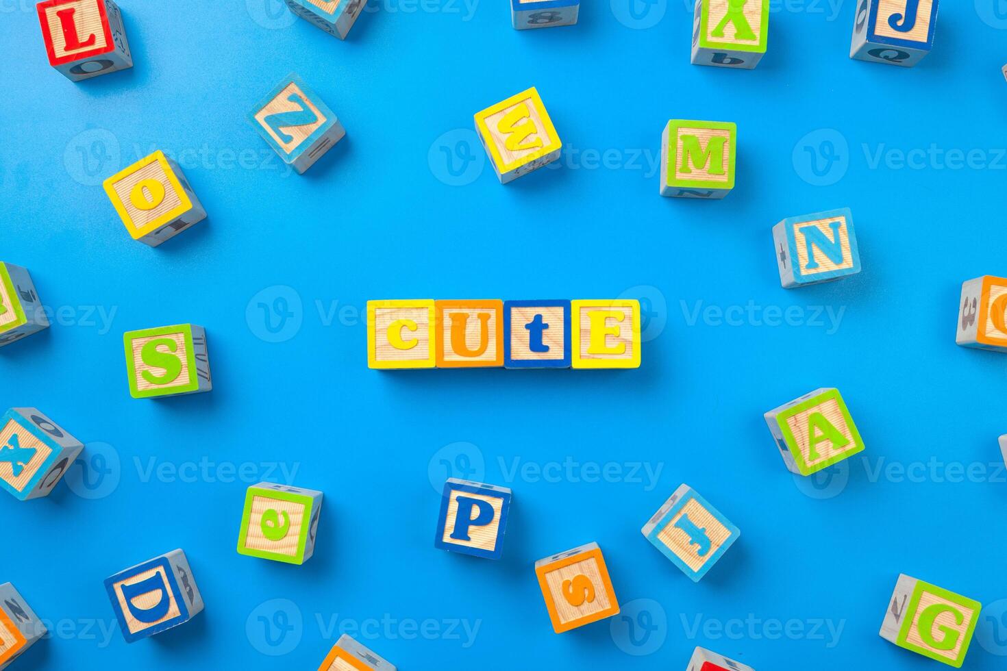 Cute. Wooden colorful alphabet blocks on blue background, flat lay, top view. photo