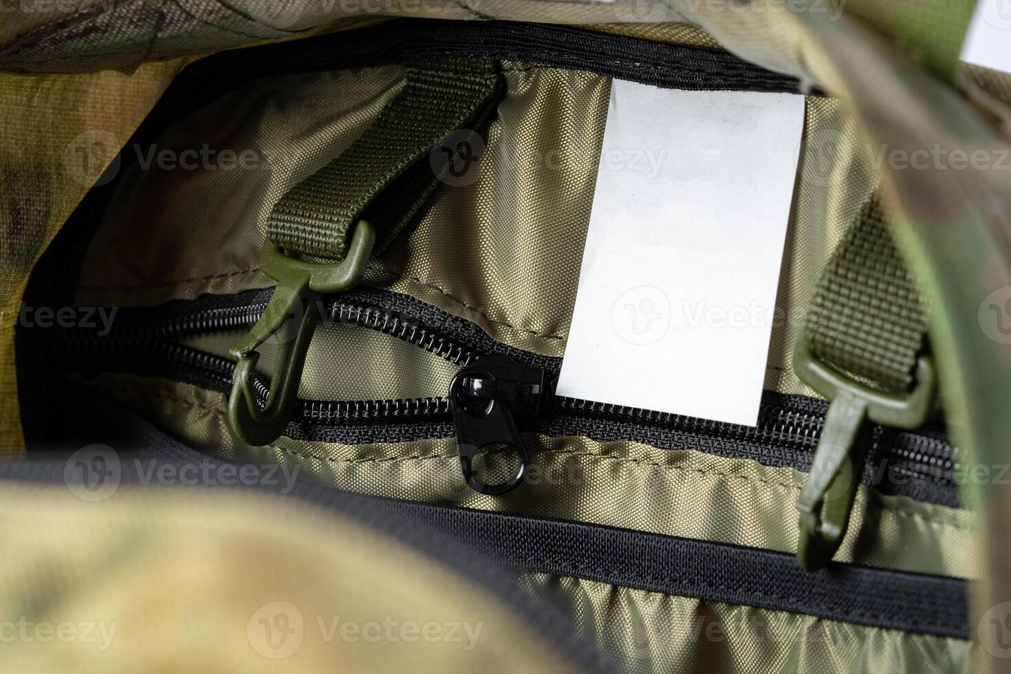 Open military backpack of khaki color on a white background photo
