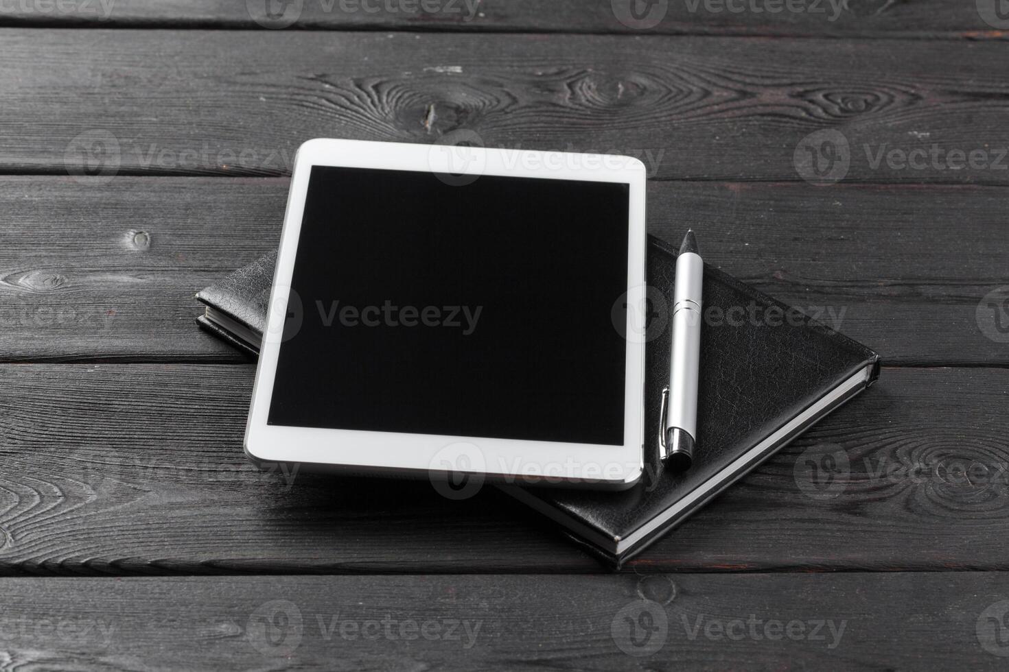 Empty digital tablet with notebook photo