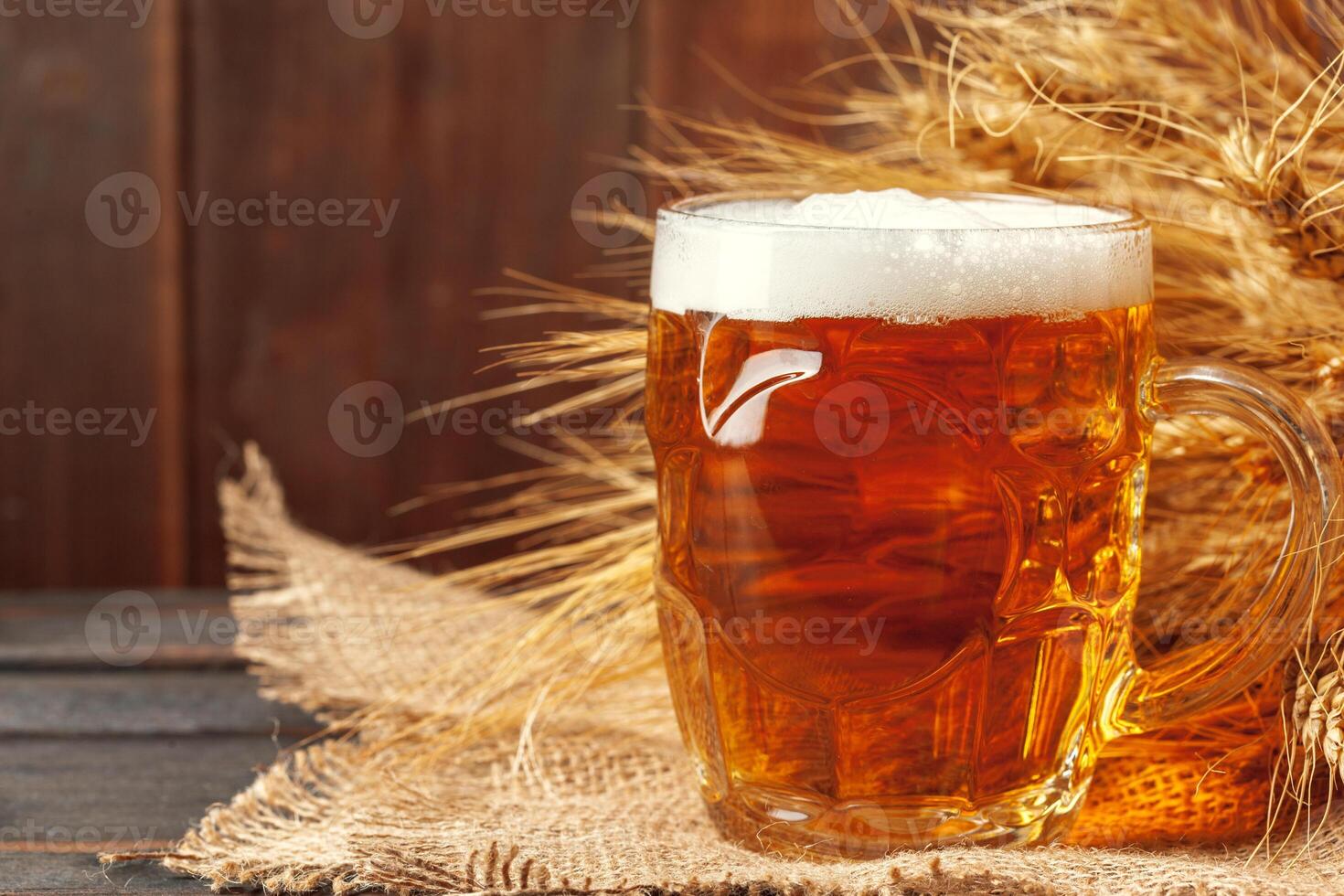 Glass beer on wood background photo