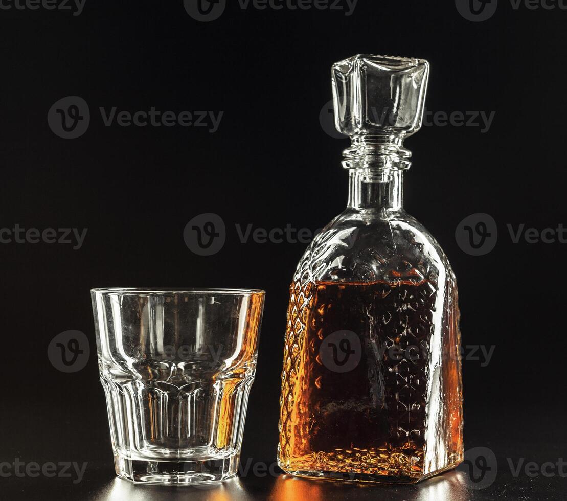 Glass of the whiskey and a square decanter photo