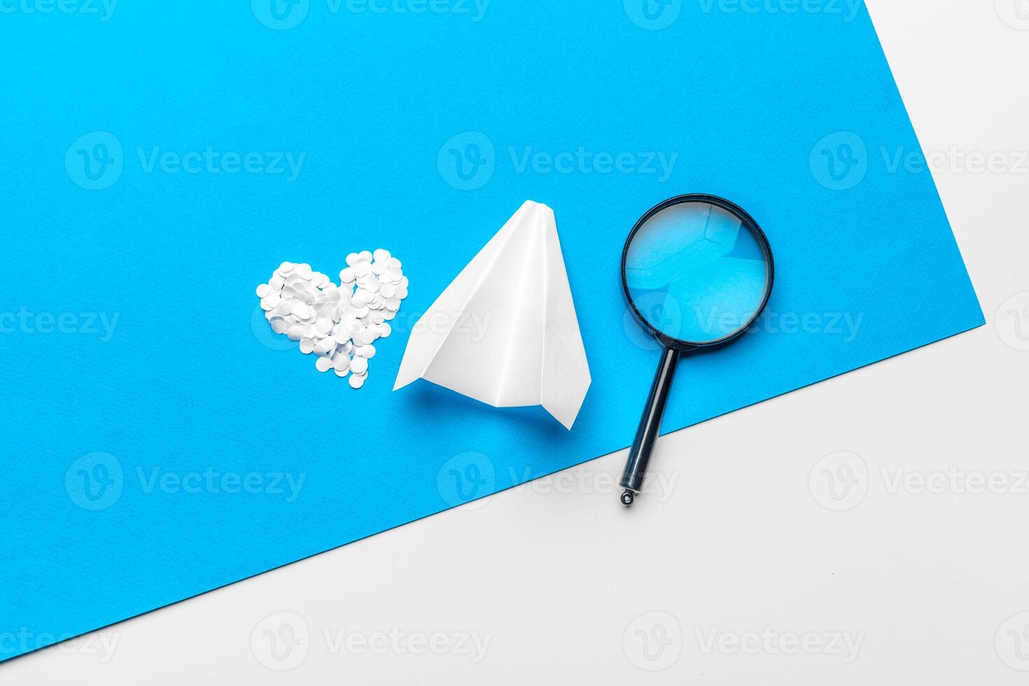 paper plane with office supplies on blue background photo
