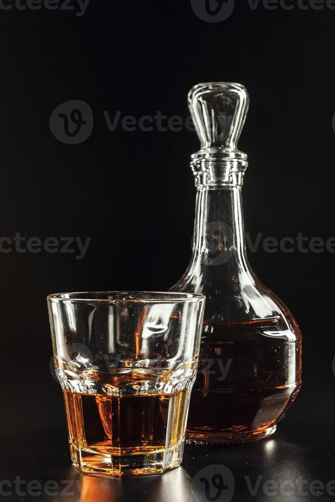 Glass of the whiskey and a square decanter photo