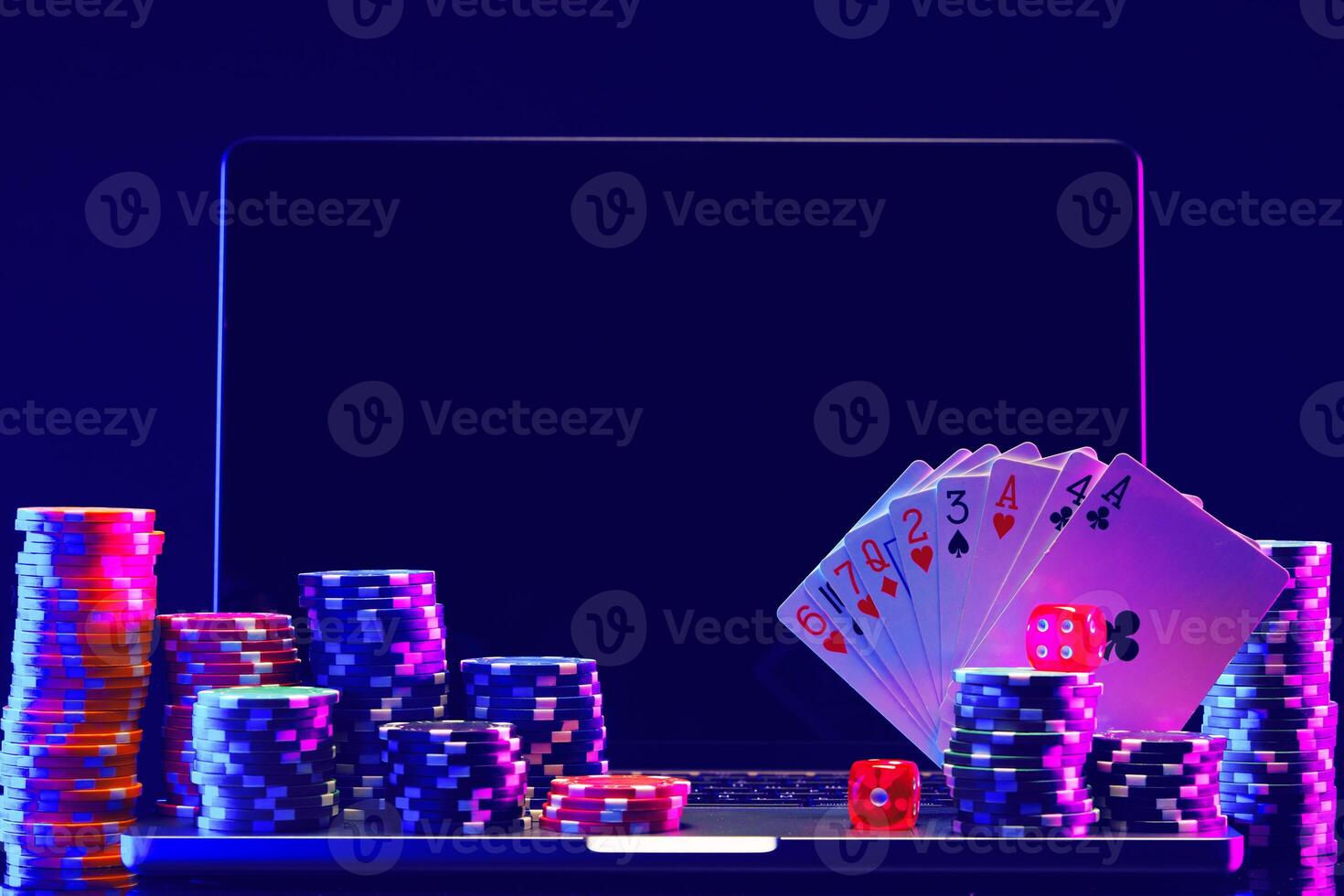 Laptop With Playing Cards and Poker Chips on a Green Table photo