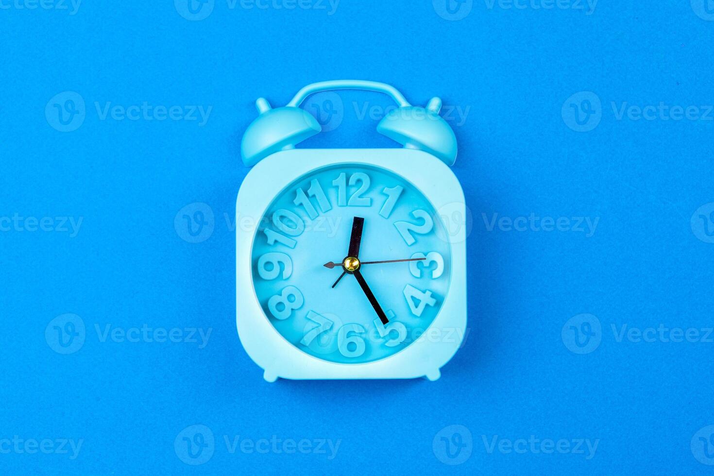 Alarm clock on color background. Pastel minimalism. Copy space photo