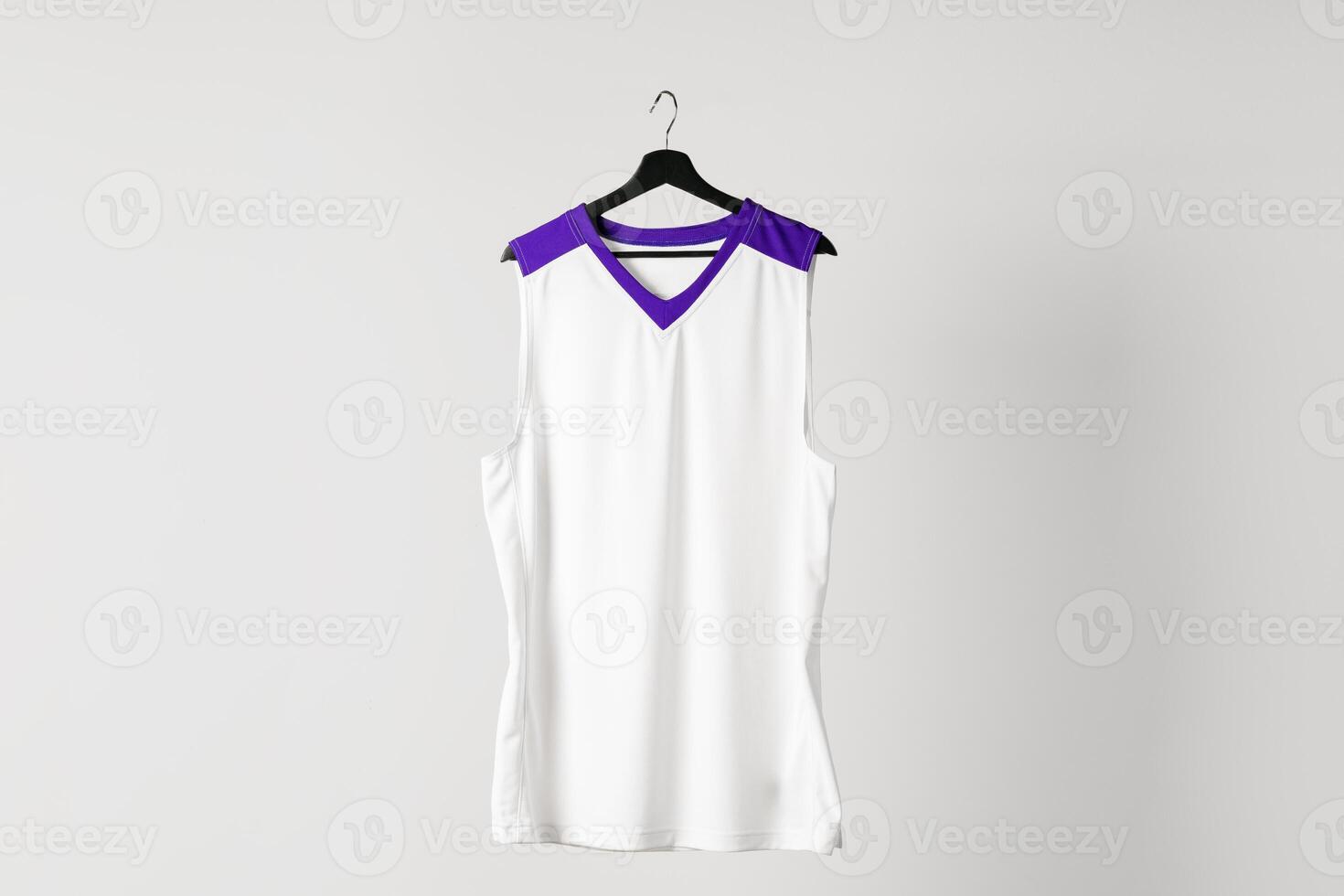 White basketball jersey hanging against white background photo
