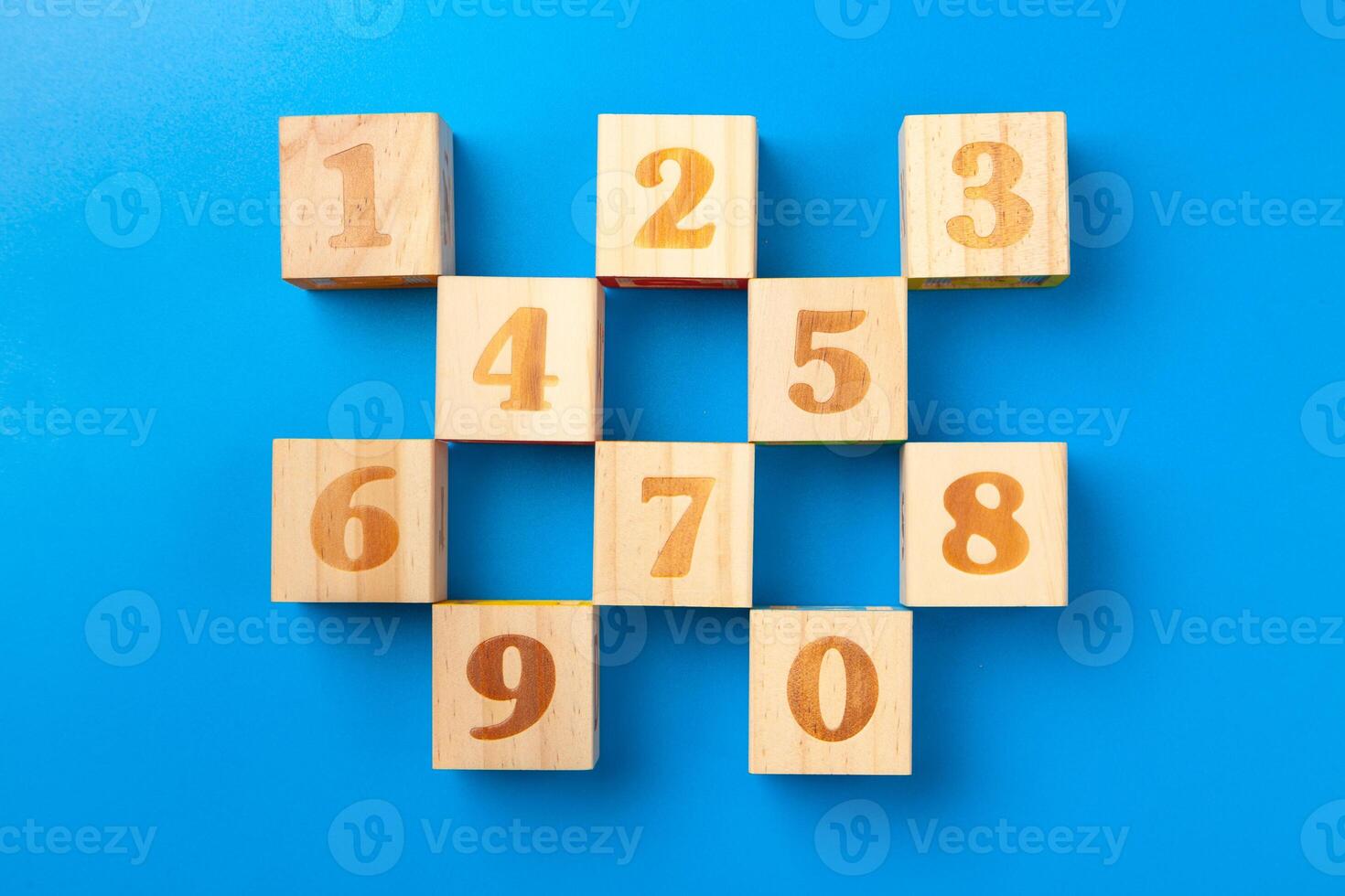Numbers. Wooden colorful alphabet blocks on blue background, flat lay, top view. photo