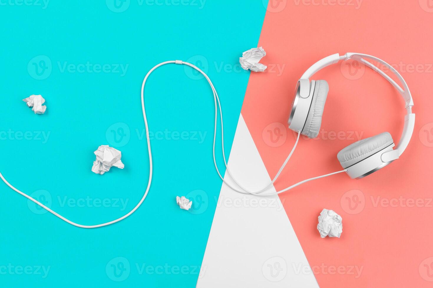 Headphones with cord on a bright color block background photo