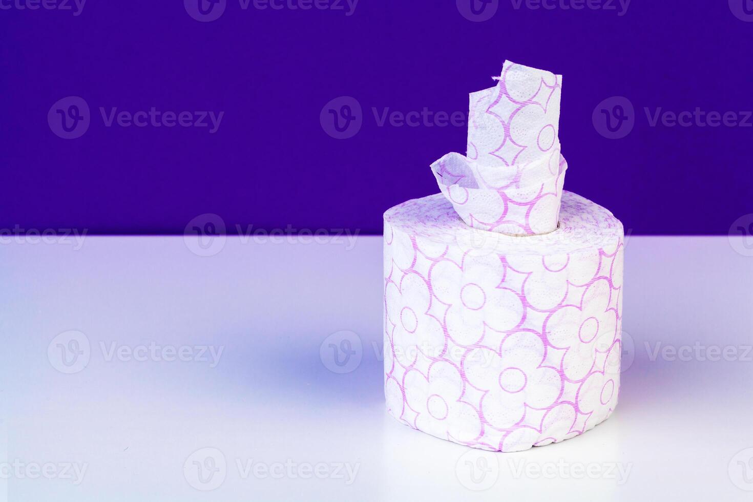 Roll of toilet paper or tissue on color background photo