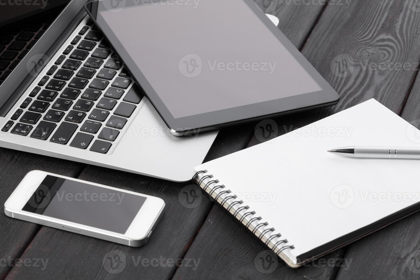 Open laptop with digital tablet and smartphone close up photo