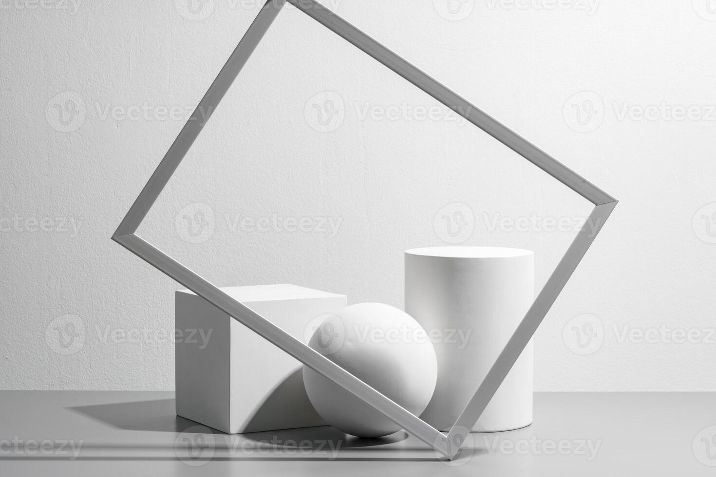 Abstract composition featuring three white geometric shapes in a minimalist interior setting photo
