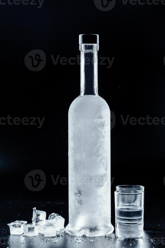 Bottle of cold vodka on dark background photo
