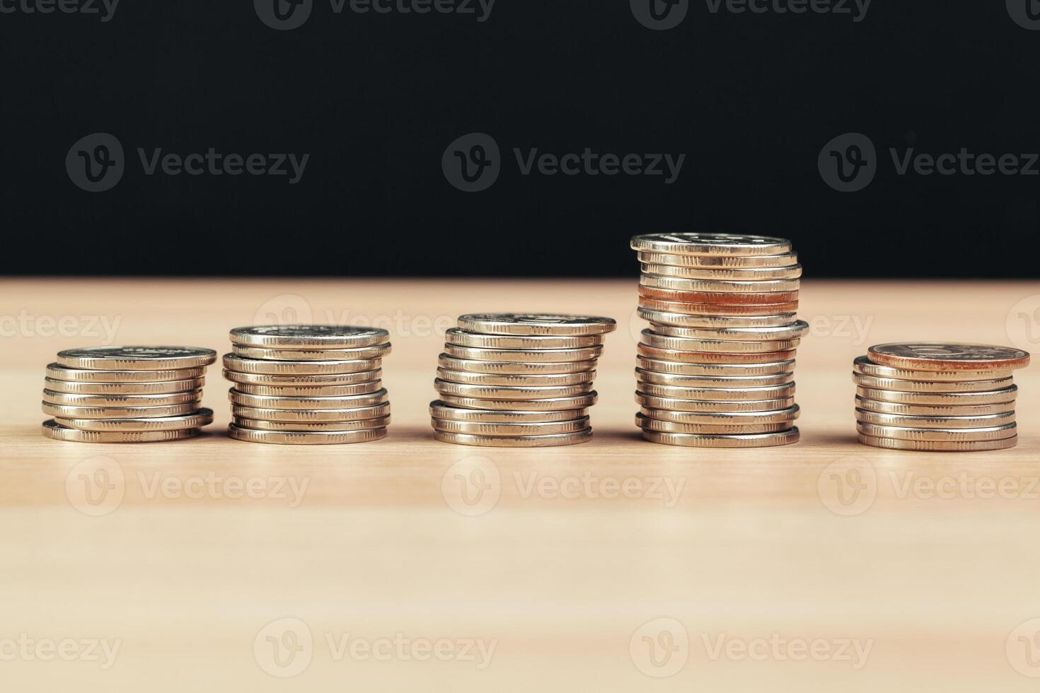 piles of coins on working table photo