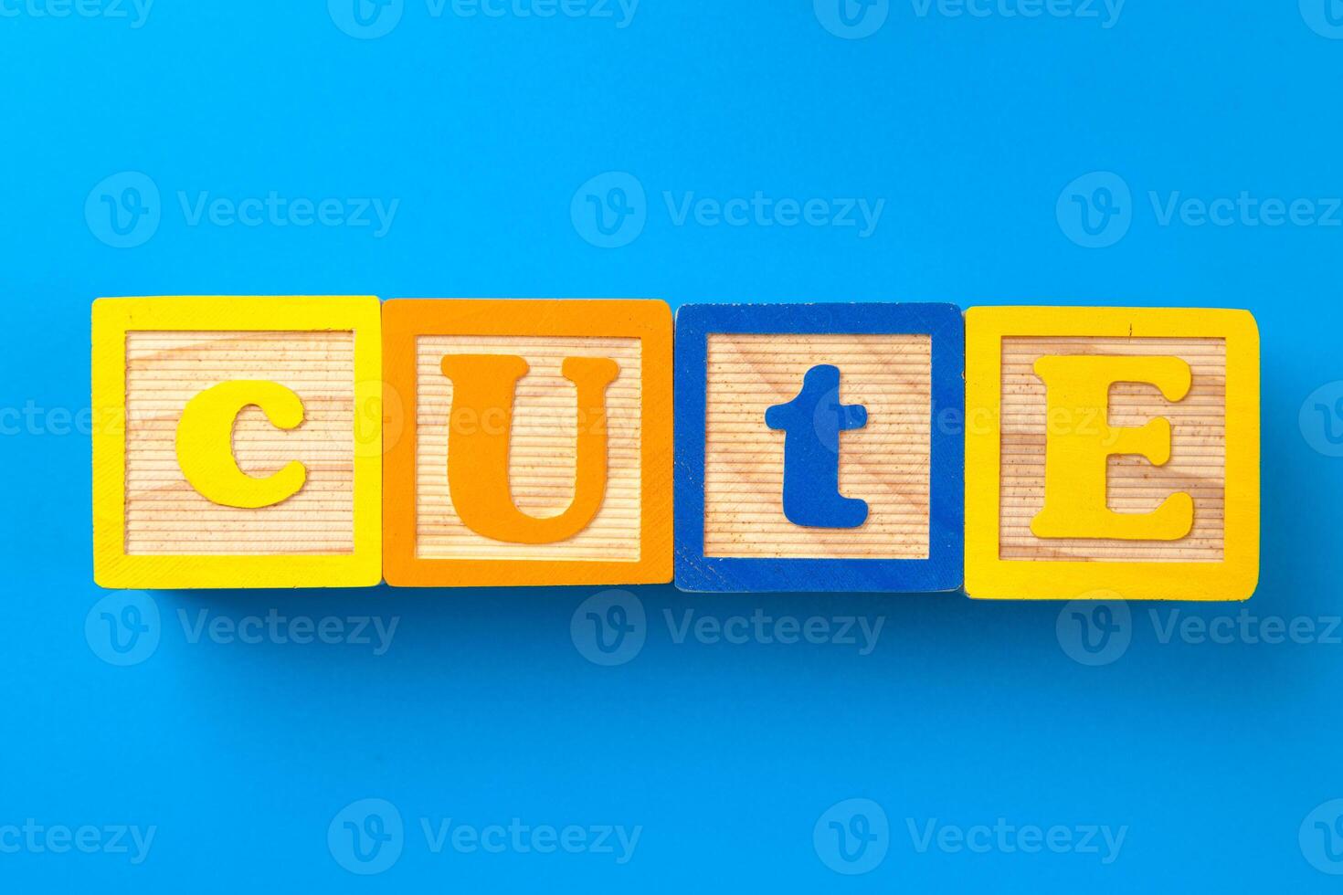 Cute. Wooden colorful alphabet blocks on blue background, flat lay, top view. photo