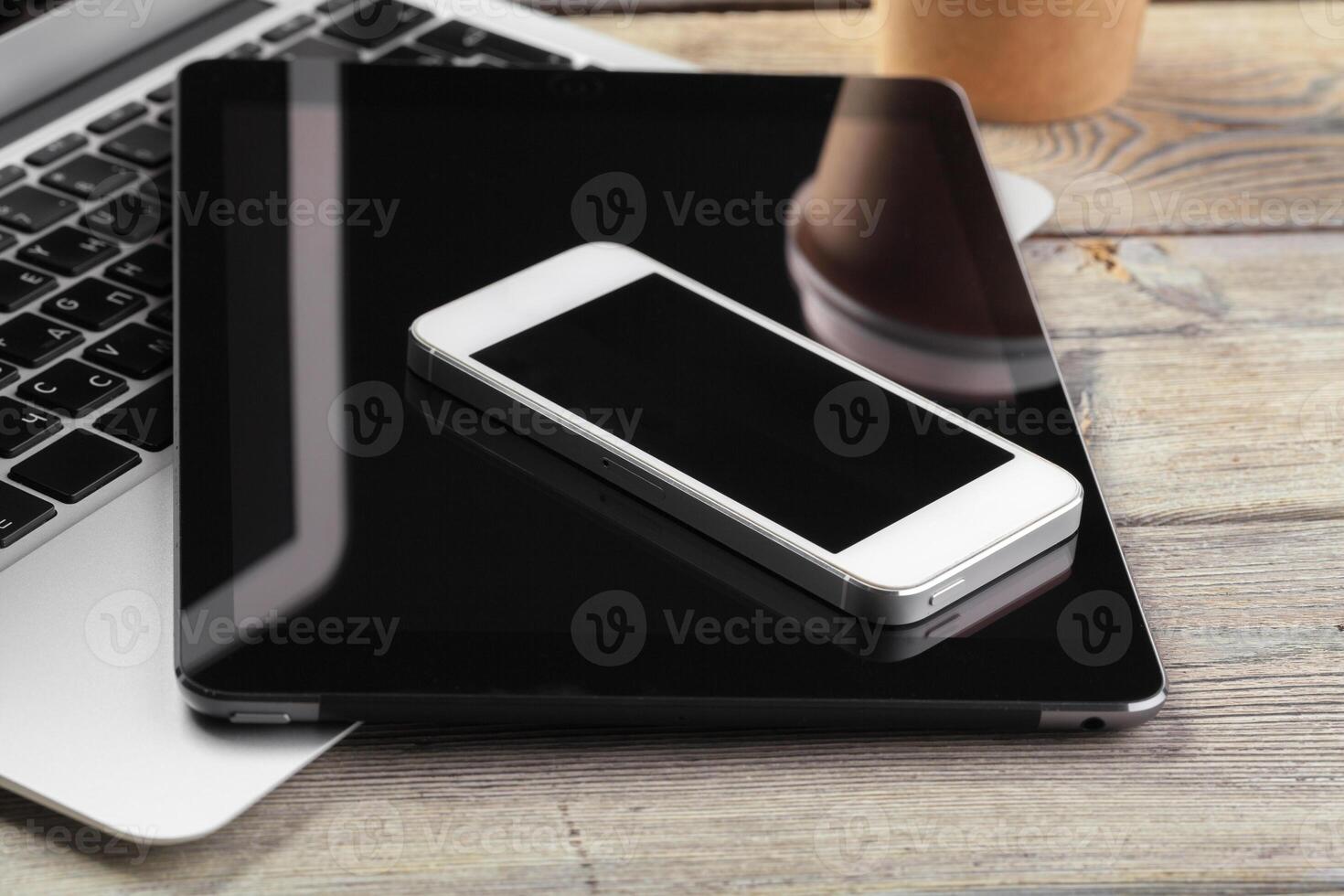 Open laptop with digital tablet and smartphone close up photo