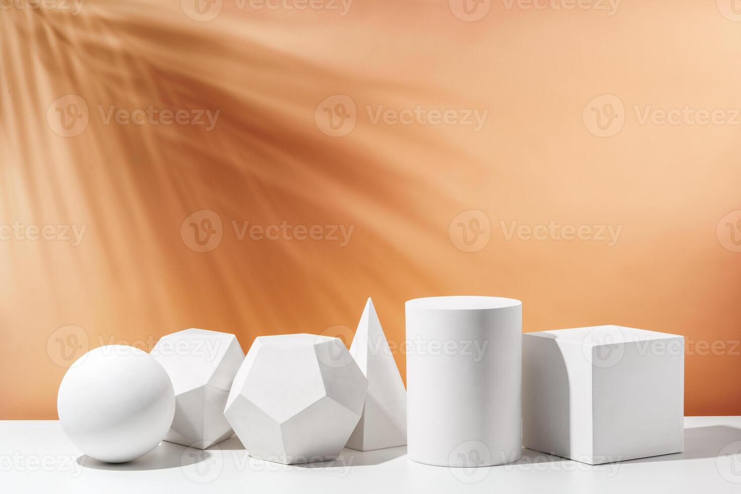 Various geometric shapes arranged artistically on a table with a warm, soft background during daylight photo