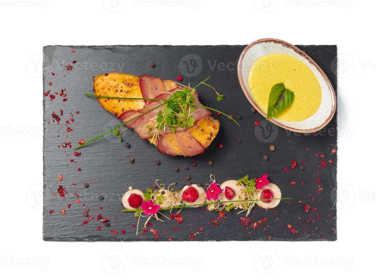 Chicken fillet with grilled bacon isolated on white photo
