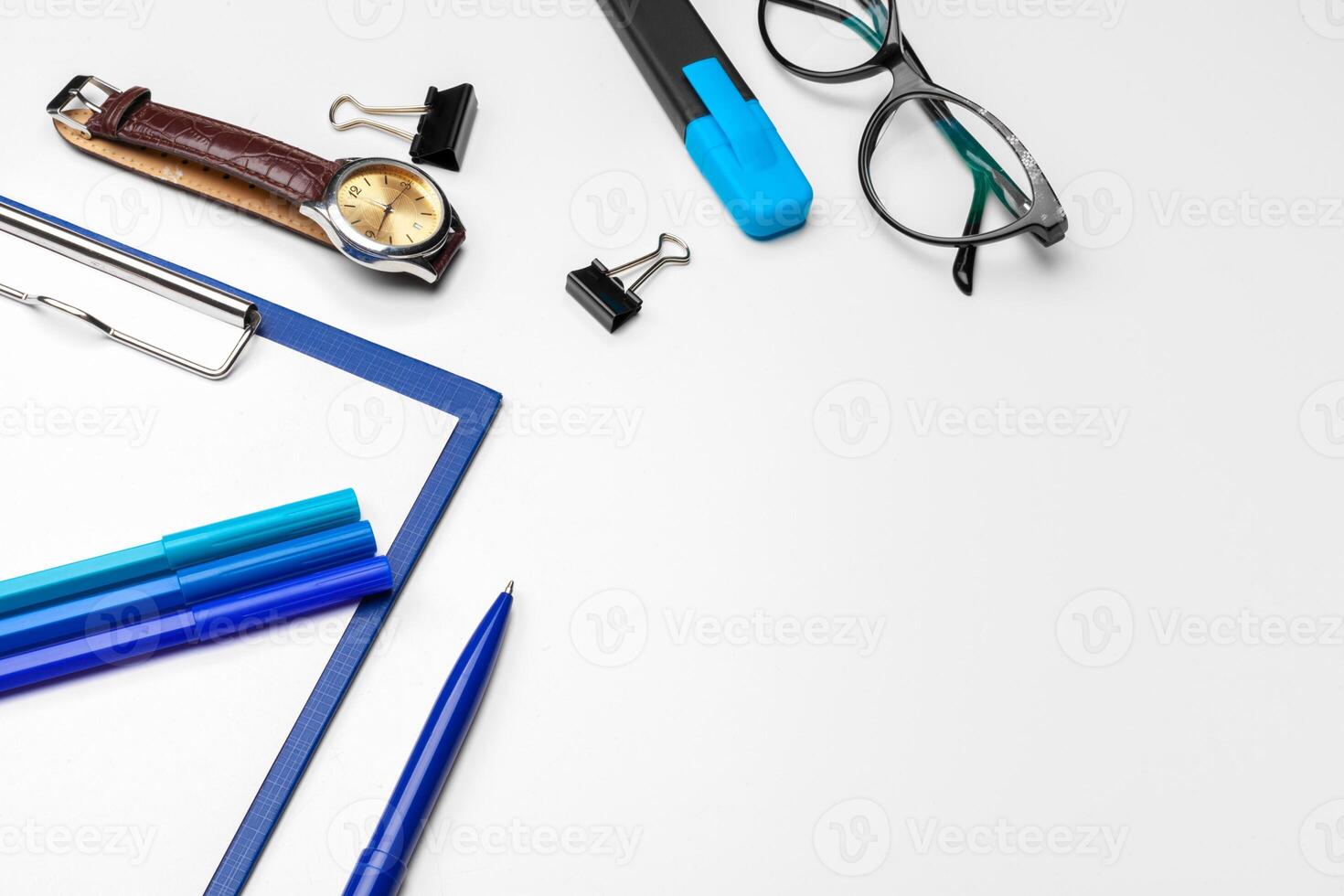 Clipboard with white sheet and pen isolated on a white background. Top view photo