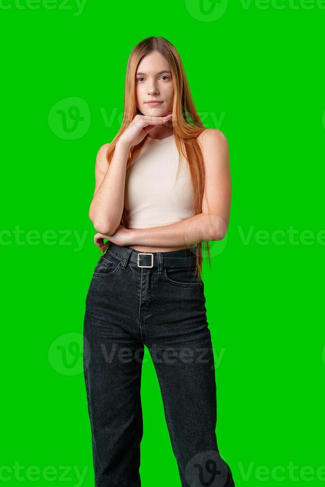 Woman With Long Hair Contemplating While Posing Against a Green Screen photo
