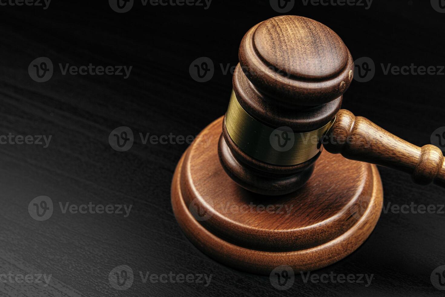 Judge's gavel on wooden table in dark photo