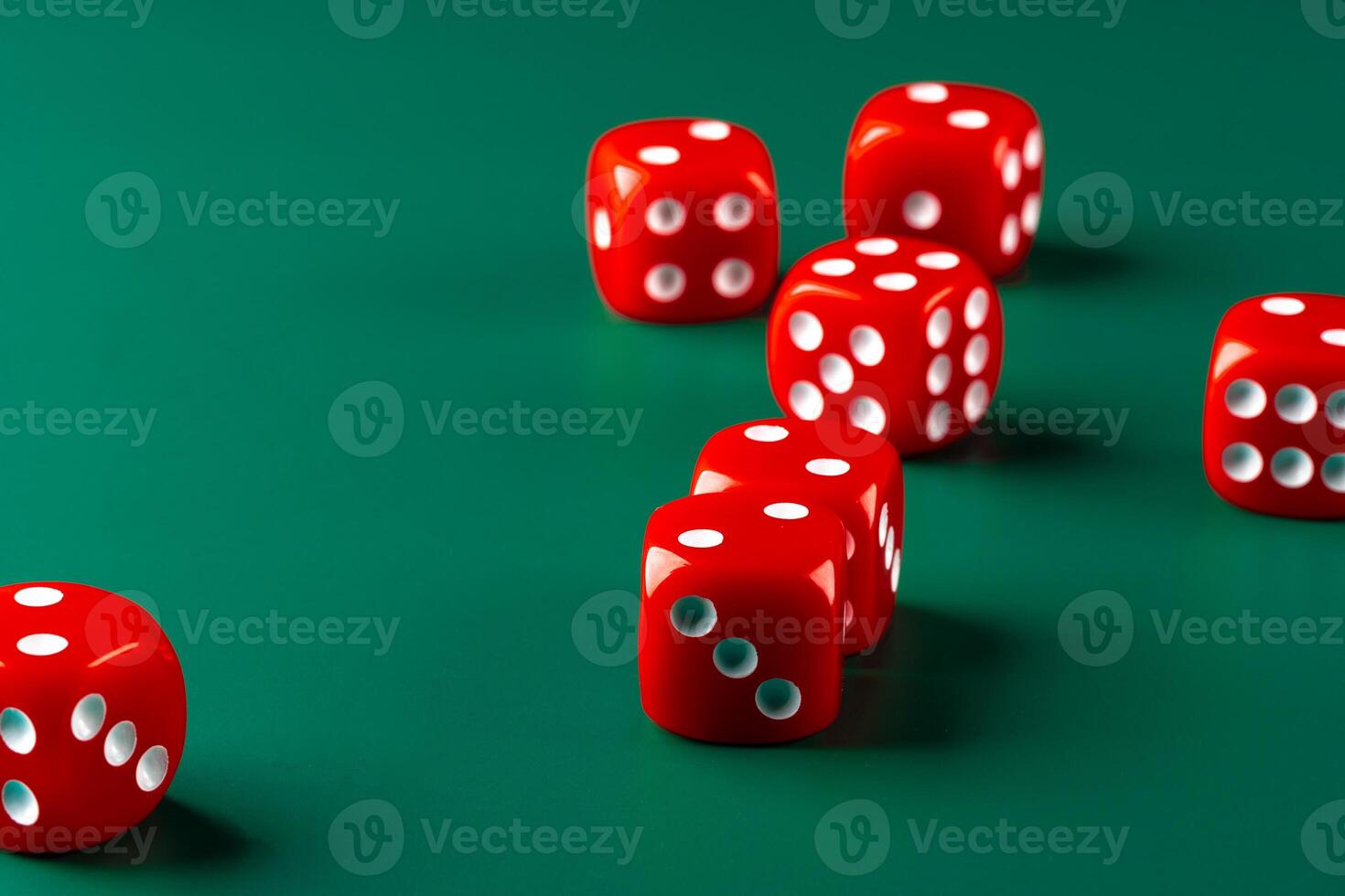 Red dice on green background close up photo