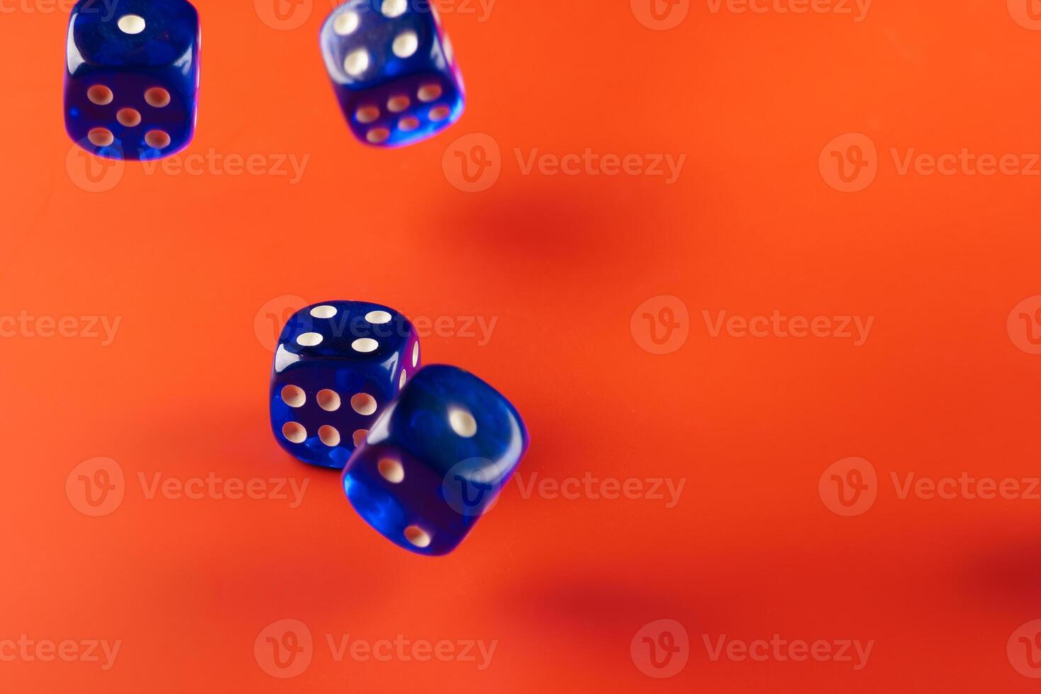 Blue dice on red background close up photo