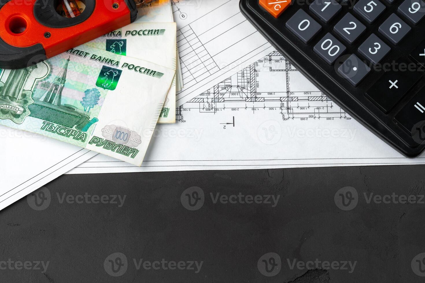 Russian roubles stack on blueprints wth calculator. Renovation, building expenses concept photo