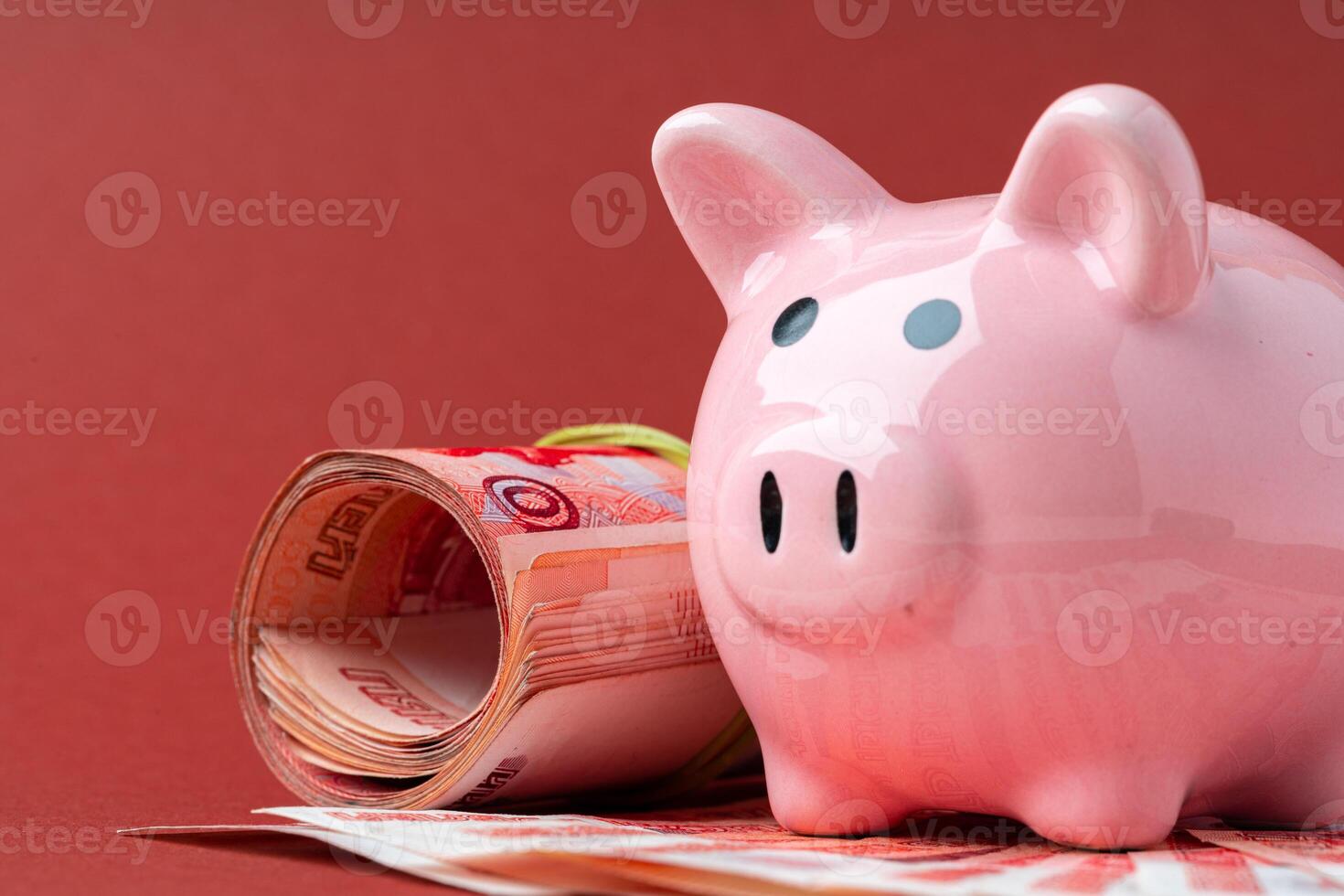 Multicurrency basket concept. Piggy bank with banknotes of russian roubles photo