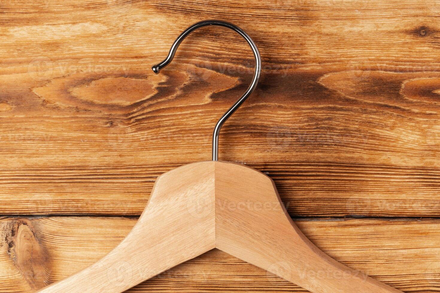 Composition with clothes hangers on wooden background. photo