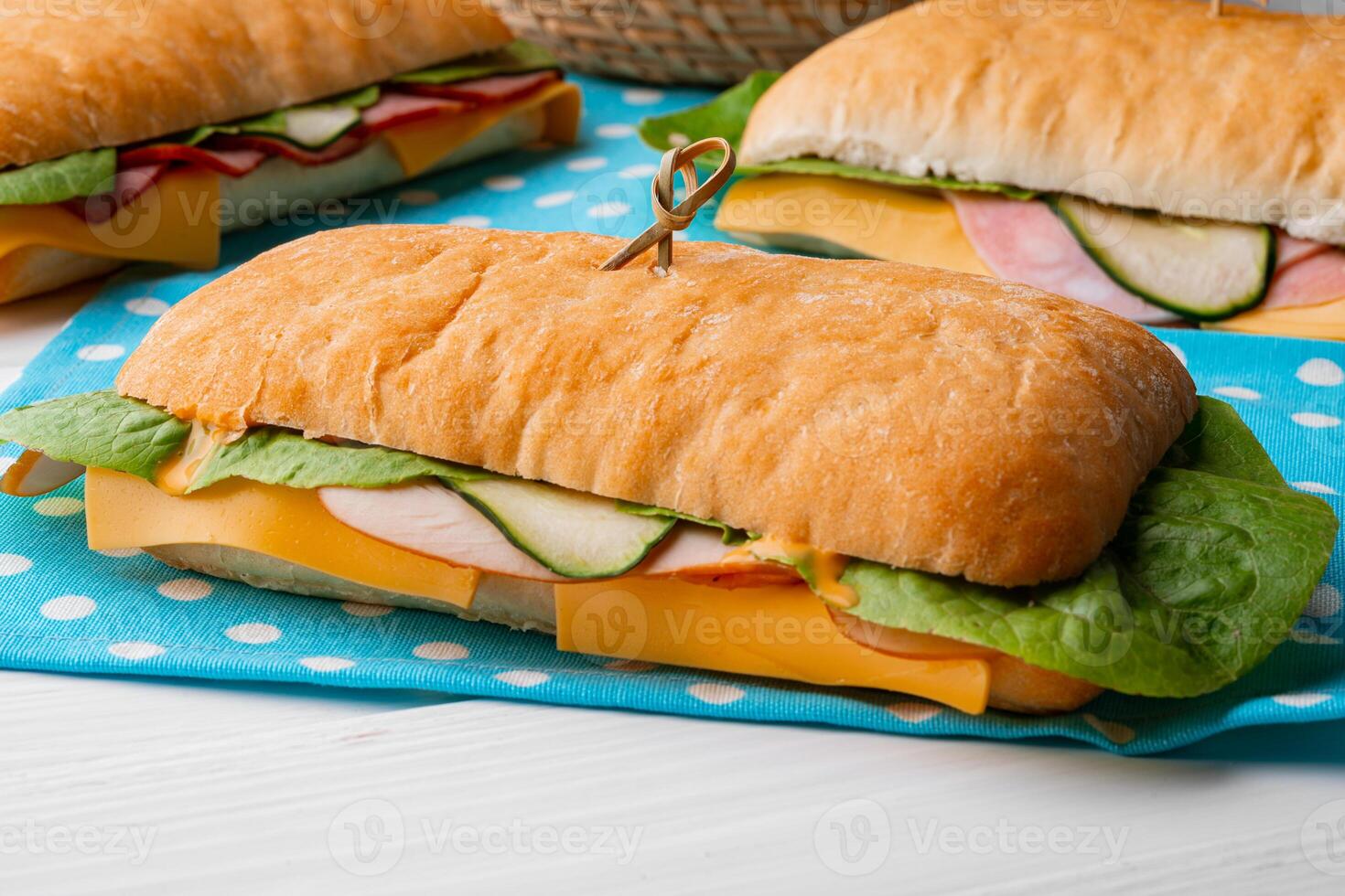 Fresh sandwich with sausage and lettuce on table photo