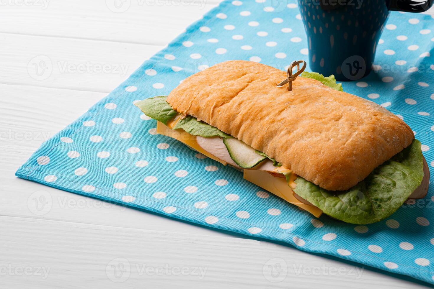 Ham sandwich with cheese and lettuce on table photo