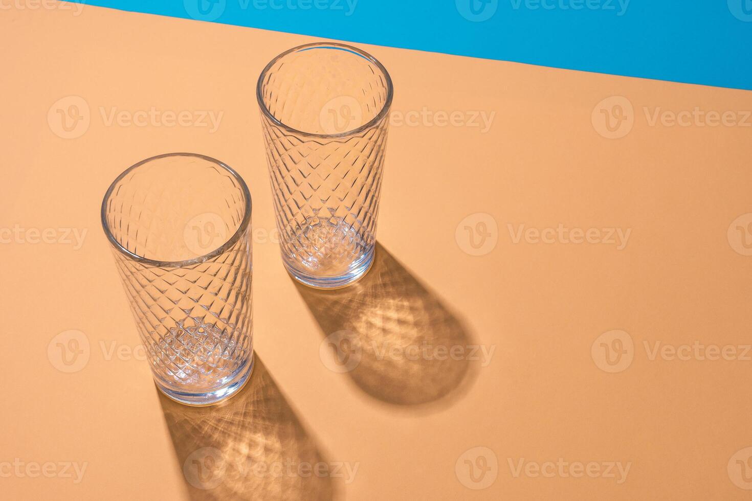 Empty transparent glass on a color background with copyspace. photo