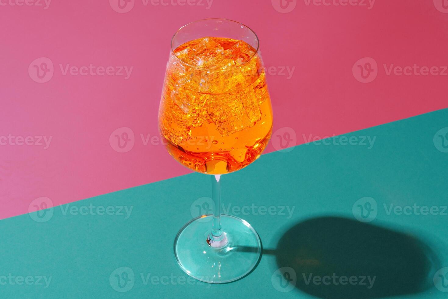 Glass of fresh cocktail on color background photo