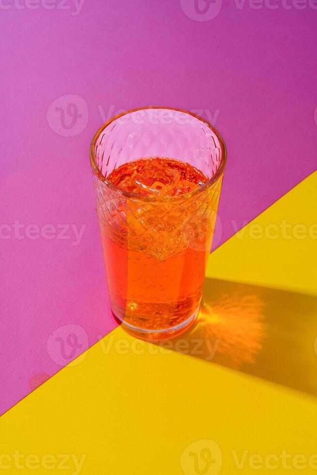 Glass of fresh cocktail on color background photo