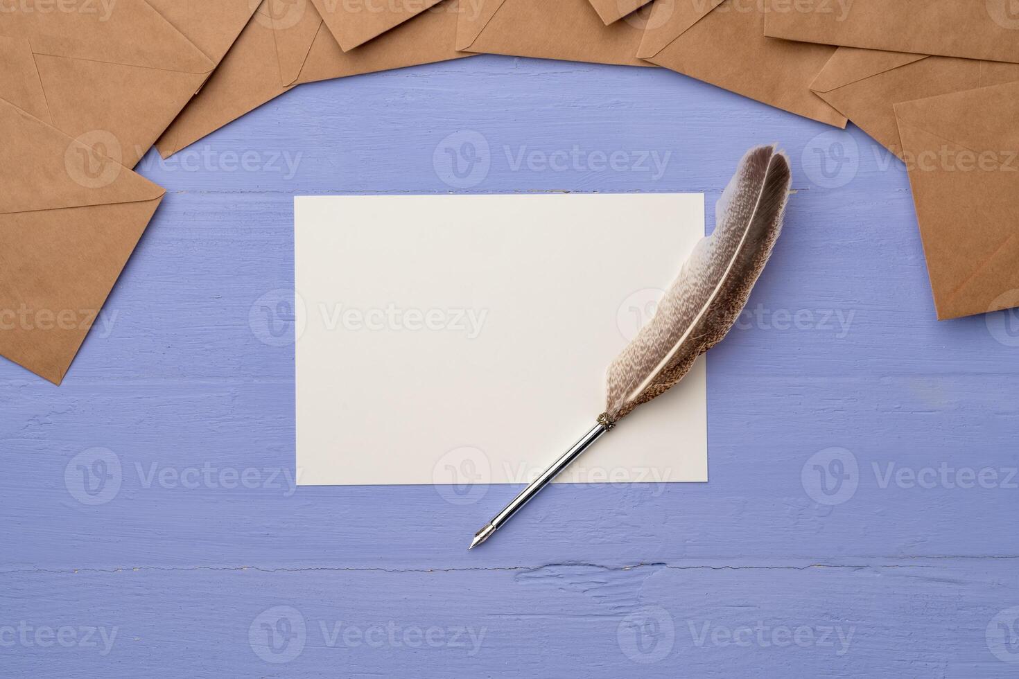 Blank paper with feather and envelopes on lavender wooden table photo