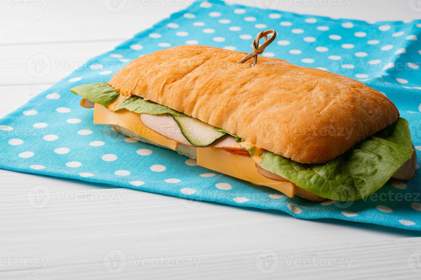 Ham sandwich with cheese and lettuce on table photo