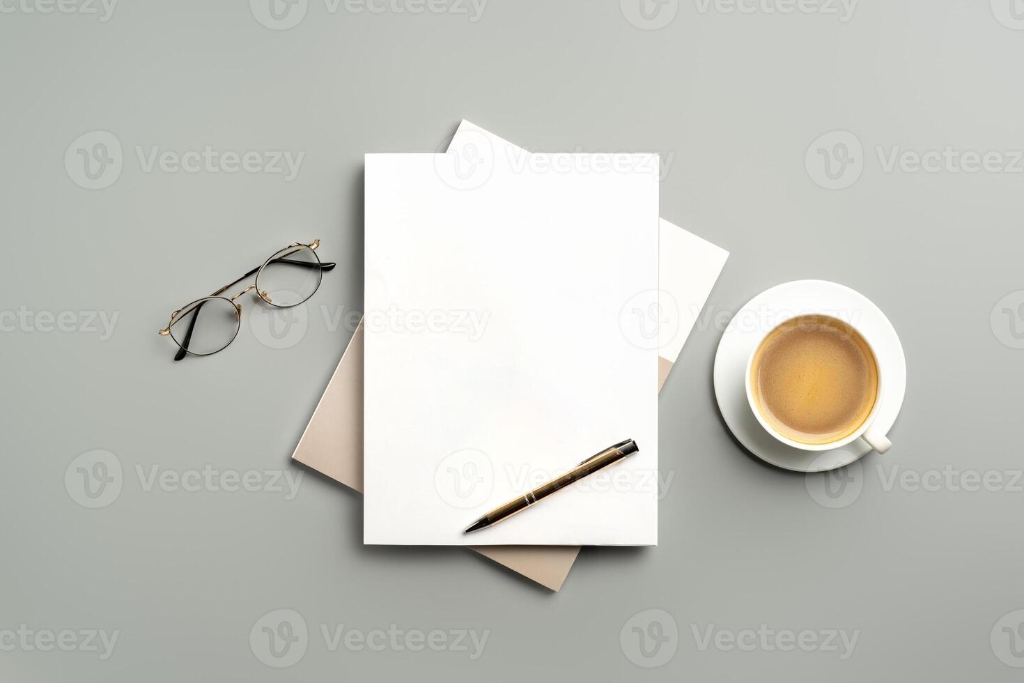 Cozy Workspace With Notepad, Pen, Glasses, and Coffee on Minimalist Desk photo