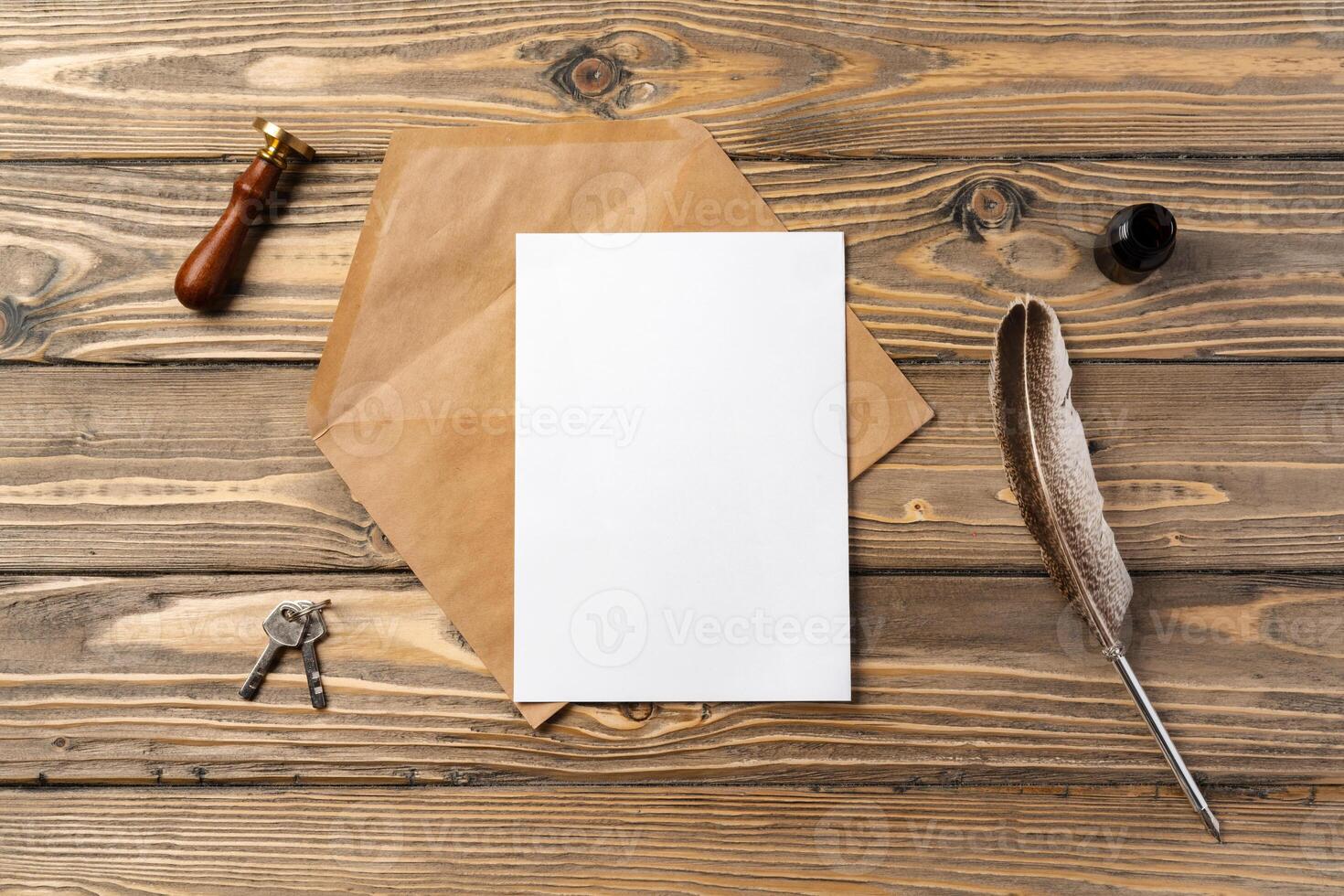 Vintage envelope with empty card, pen on wooden table top view photo
