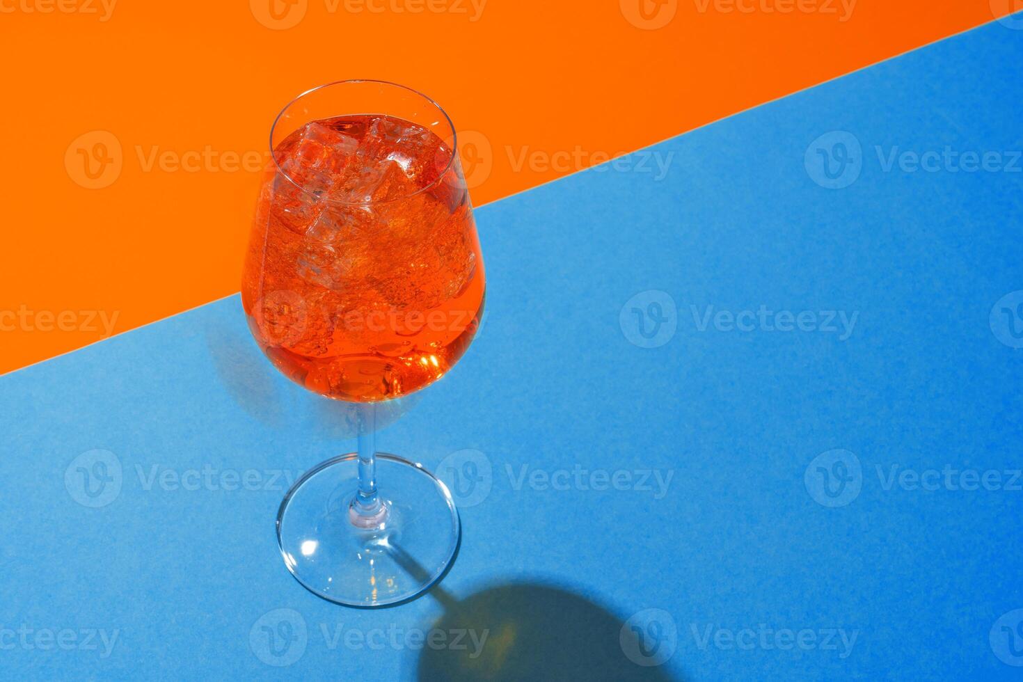 Glass of fresh cocktail on color background photo