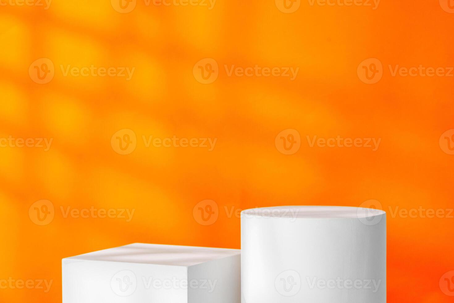 White geometric shapes on a vibrant orange background with soft shadows in a well-lit indoor setting photo