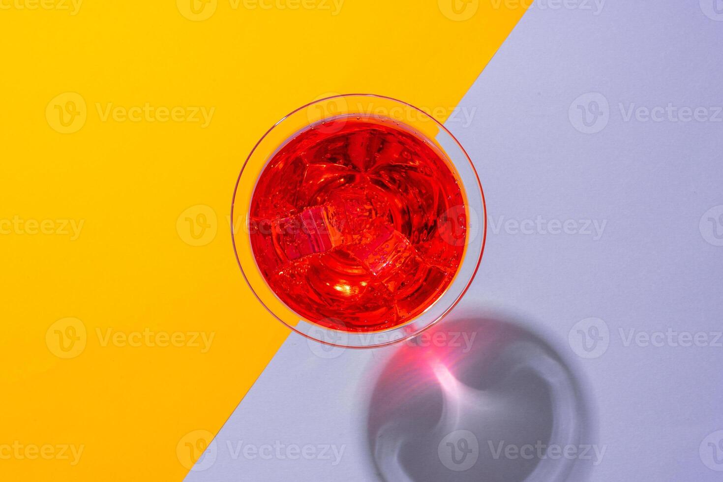 Glass of fresh cocktail on color background photo