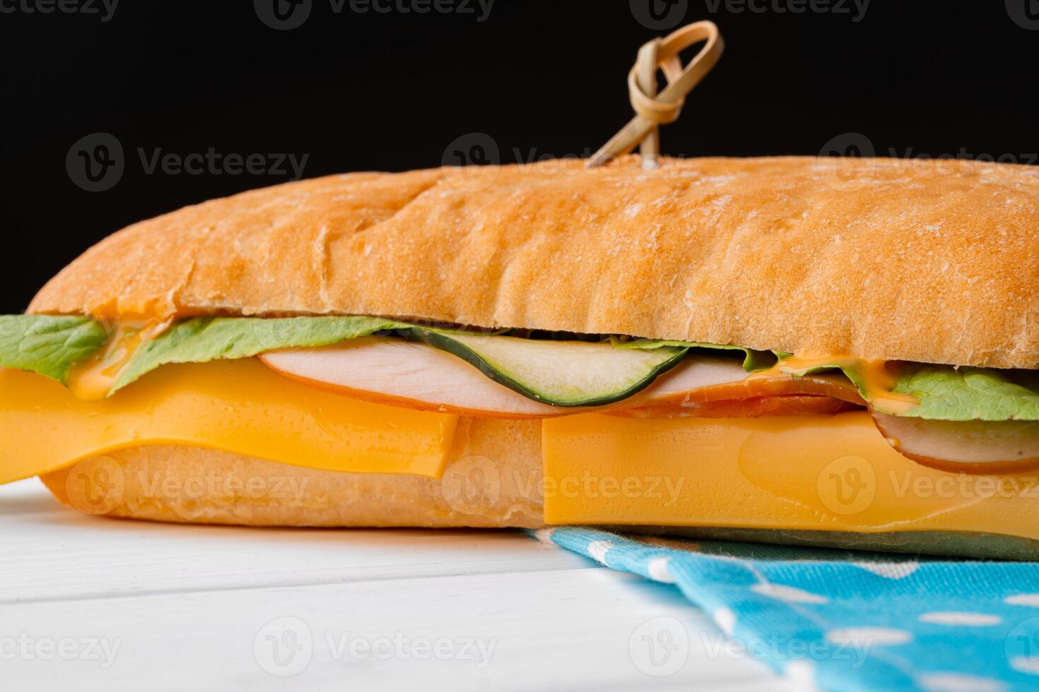 Ham sandwich with cheese and lettuce on table photo