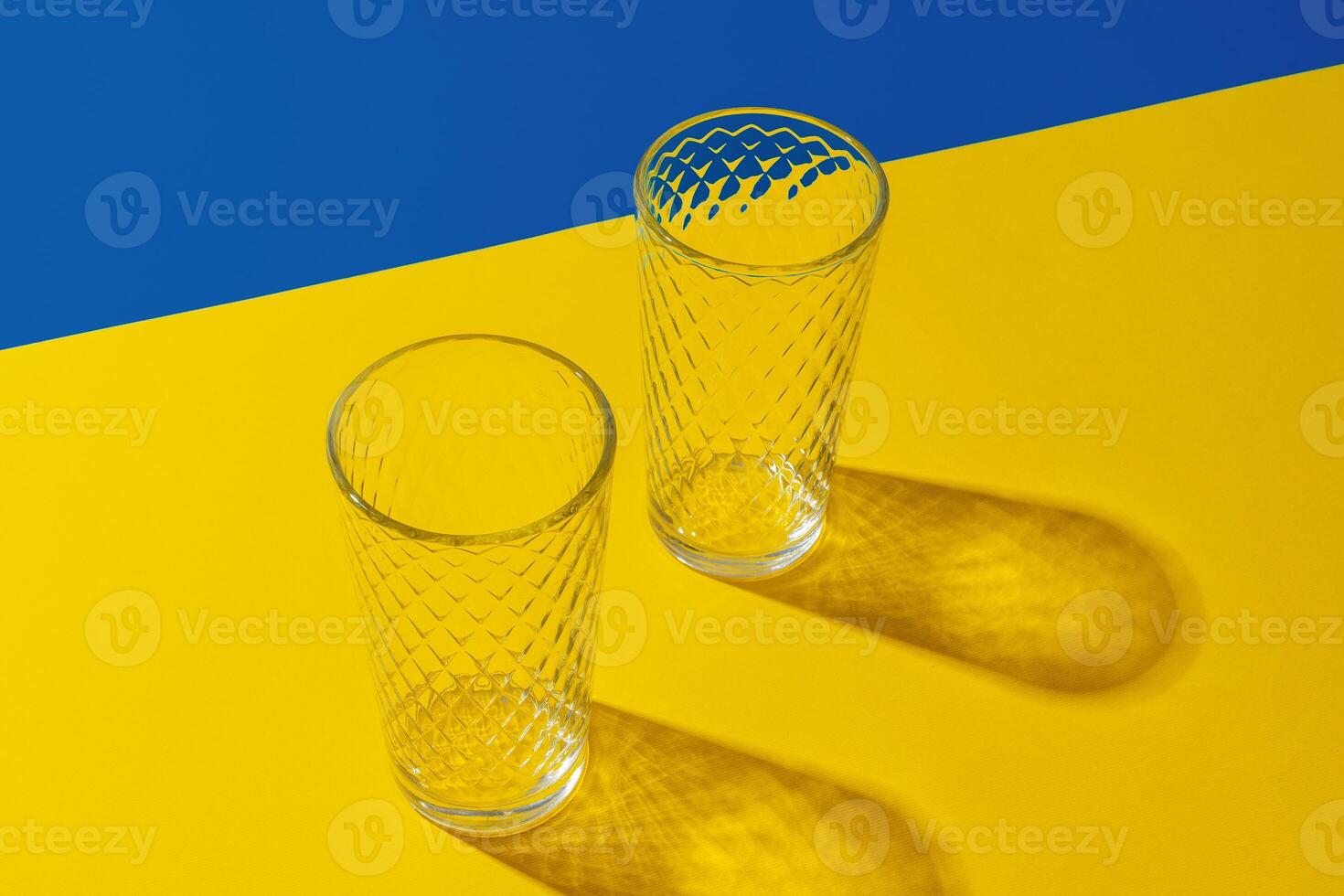 Empty transparent glass on a color background with copyspace. photo