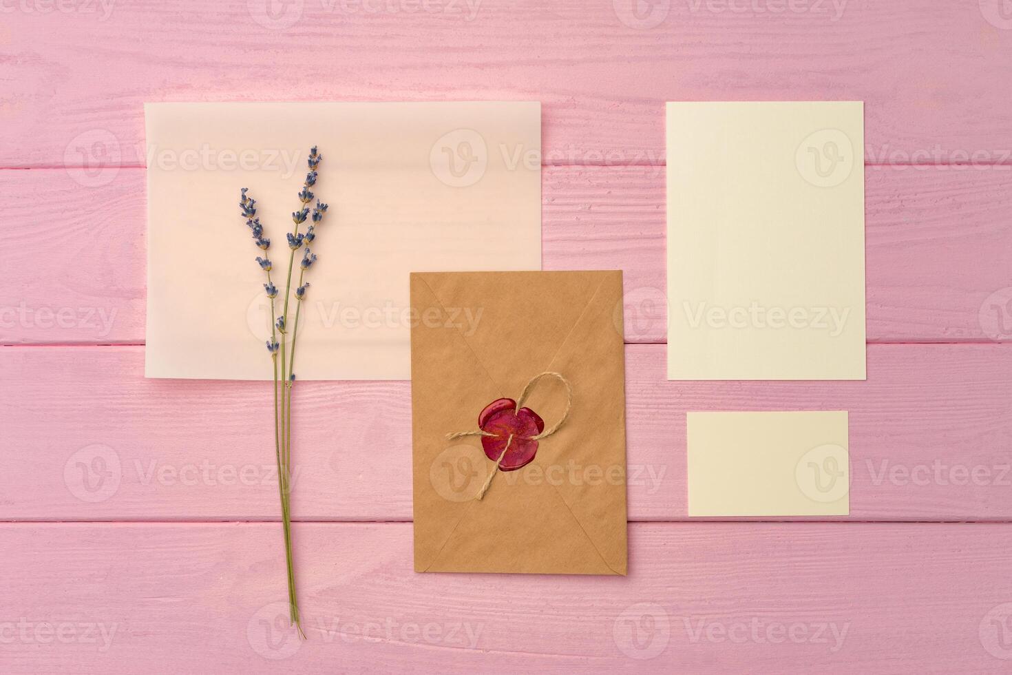 Envelope with letter on pink wooden background top view photo