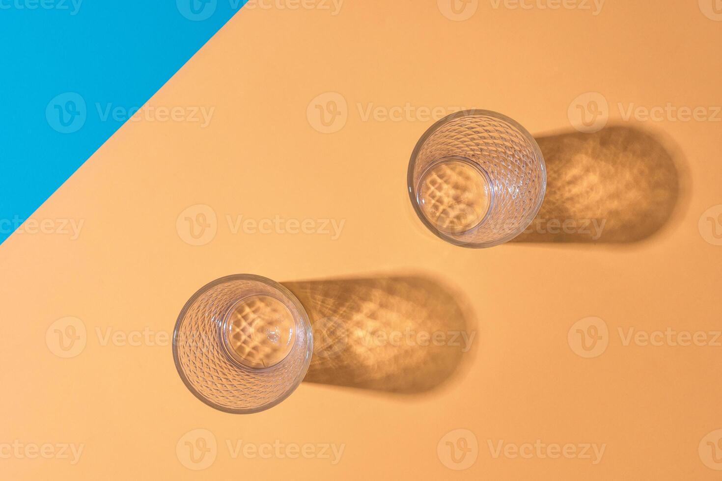 Empty transparent glass on a color background with copyspace. photo