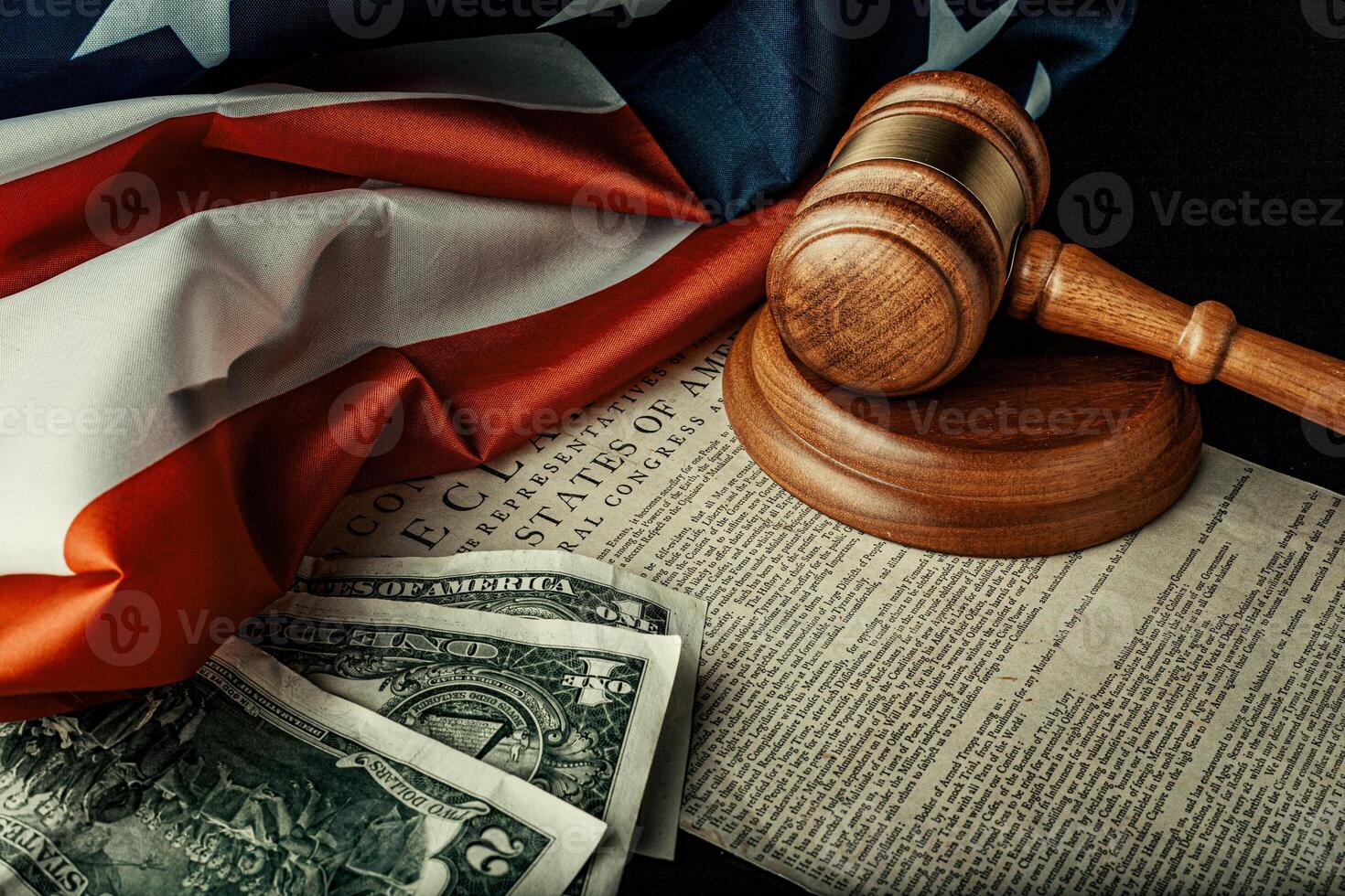 Wooden judge mallet with Dollars notes on the USA flag with Declaration of Independence photo